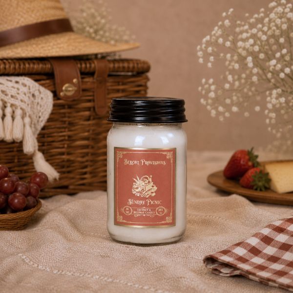 Candle labeled 'Sunday Picnic' with a picnic theme including a basket, fruits, and checkered cloth.