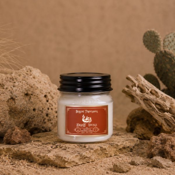 Jar of desert-themed candle with cactus and rock background