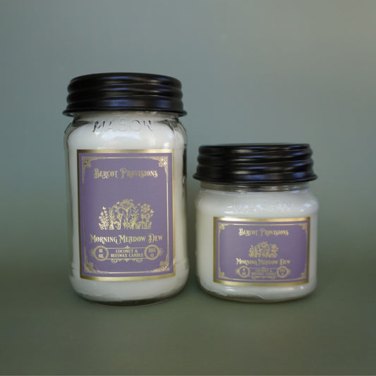 Two candles with purple labels on a gray background