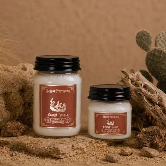 Two candles with labels on a natural background with cacti