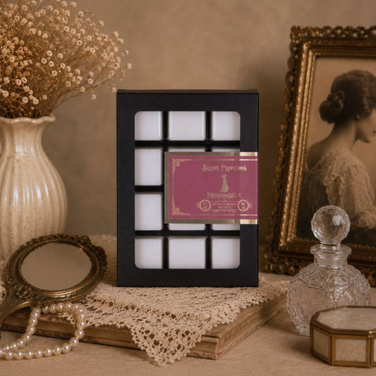 Decorative wax melt set in a black holder on a table with vintage decor items.