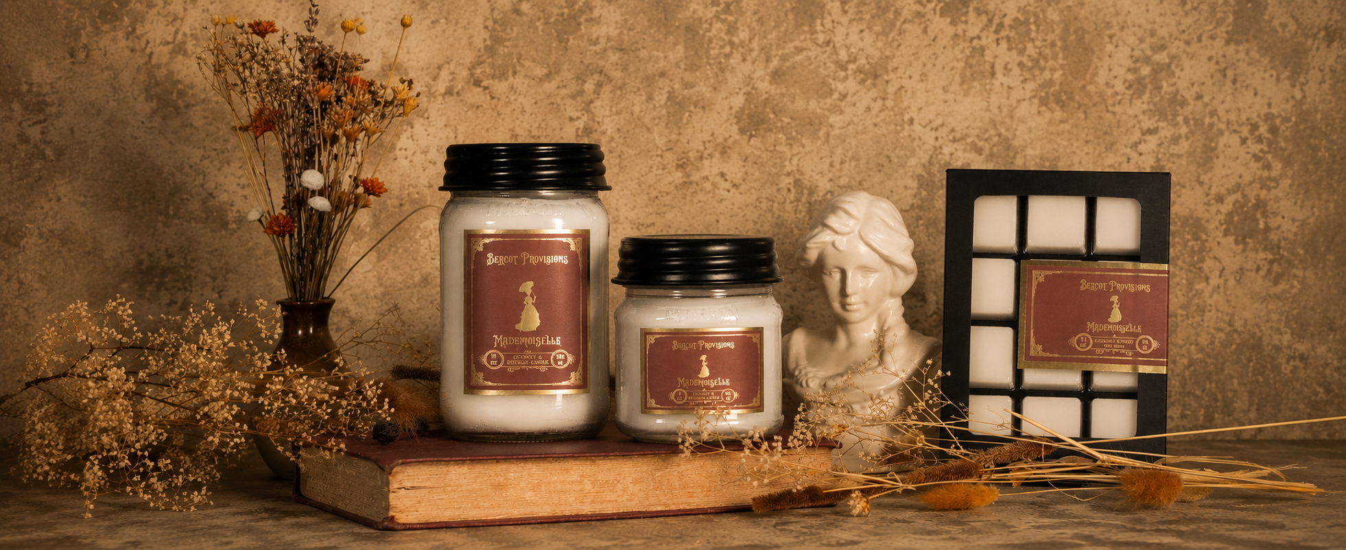 Two candles with labels and wax melts on a wooden surface with decorative elements.