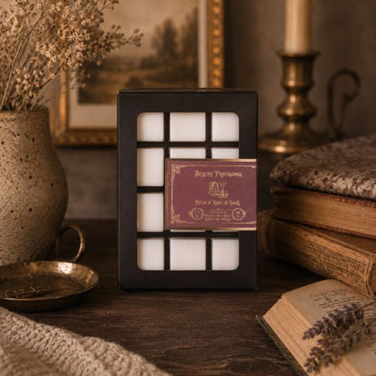 Pack of wax melts with a decorative label on a wooden surface with books and decor items.