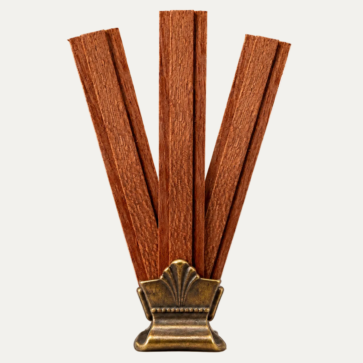 Brown wooden wicks used for Bercot Provisions' candles attached to an ornate antique bronze metal base, shown on a checkered gray and white background.